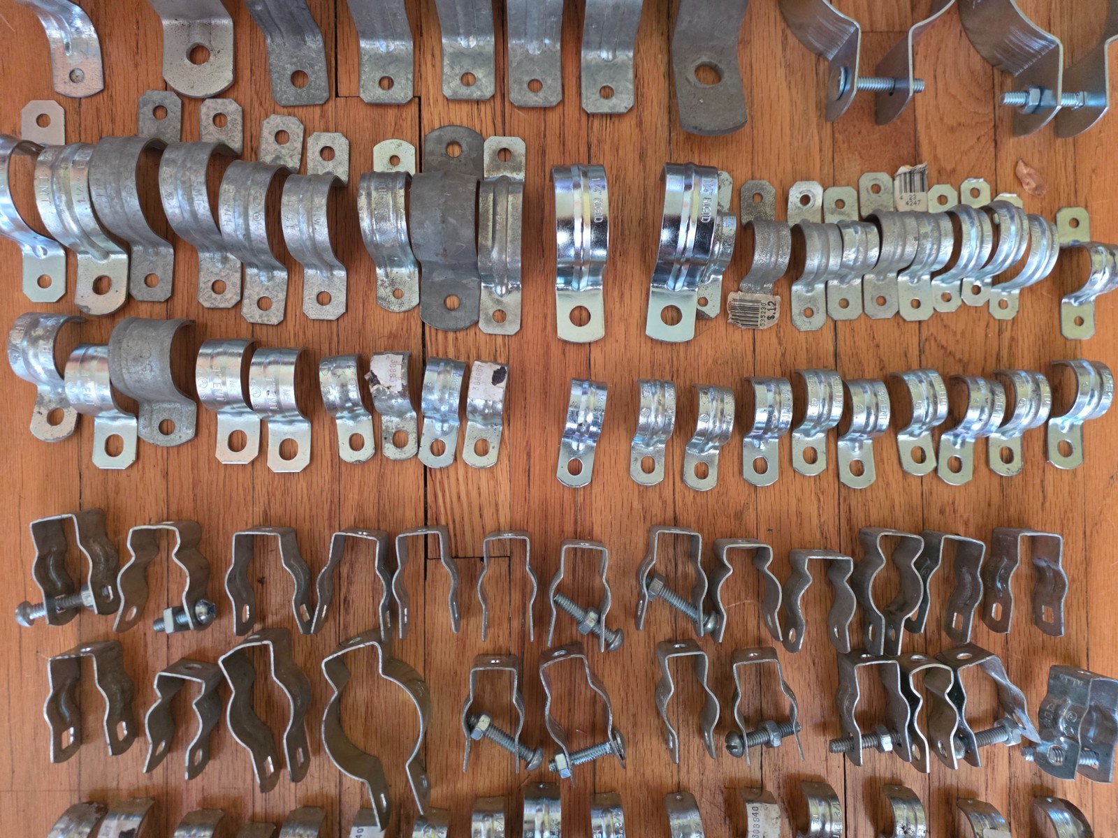 lot of 102 assorted conduit / EMT / electrical PVC hangers & straps 1/2 – 2 1/2″
